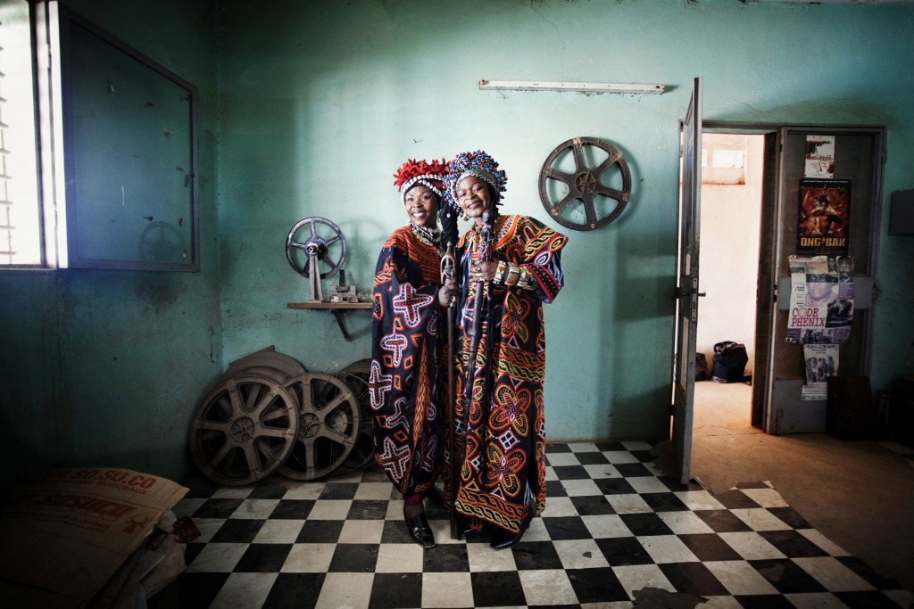 The Queen Mothers, Werewere Liking and Nserel Njock, sisters in real life, were born in Cameroon, live in Ivory Coast, but are “from Africa”, they respond to anyone who dares ask what country they are from. They sing, act, and are general cinema celebrities. They visibly enjoyed having their portrait taken, here in the projection room of cinema Patte d’Oie, on the periphery of Ouagadougou. © Andrea Frazzetta / LUZphoto